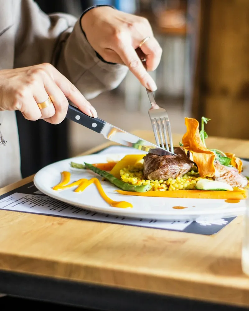 Magret de canard servi en salle avec un verre de vin blanc
